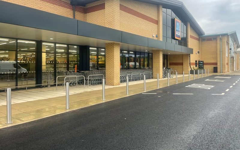 Newly surfaced ALDI car park with bay markings and kerbed walkway